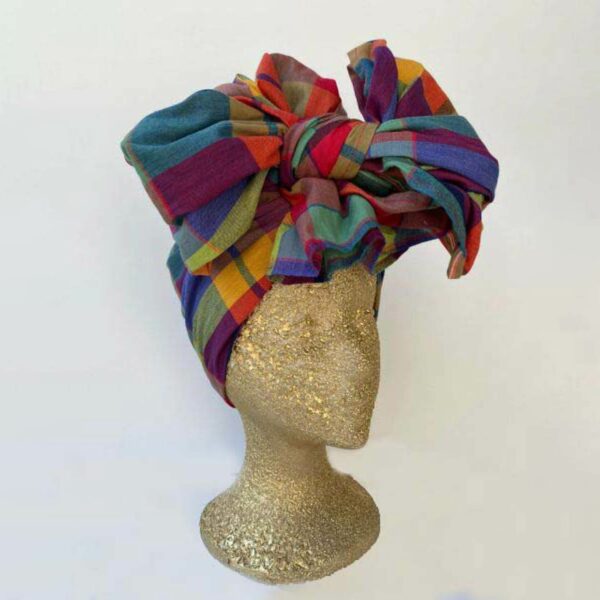 A madras headwrap on a manequin